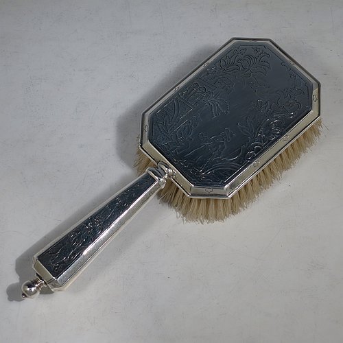 An Antique Sterling Silver hand hair brush, being a copy of a Queen Anne set, having an elongated hexagonal body with panelled handle, all hand-engraved in a Chinoiserie style, and with original bristles. Made by D. & J. Welby of London in 1915. The dimensions of this fine hand-made antique silver hair brush are length 25 cms (9.75 inches), and width 9 cms (3.5 inches).