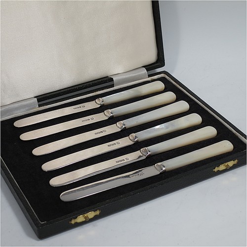 A Sterling Silver and Mother-of-Pearl handled set of six butter or tea knives, having plain mother-of-pearl handles, and plain silver parallel sided and rounded-end blades, all in their original cream satin and black velvet-lined presentation box. Made by Charles Boyton & Sons of Sheffield in 1966. The dimensions of this fine hand-made set of tea or butter knives are length of each knife 15 cms (6 inches).