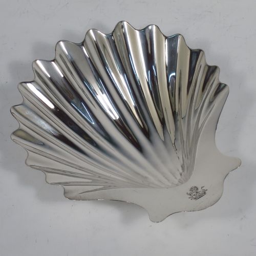 A very handsome Antique Georgian Sterling Silver butter shell, having a hand-chased traditional scallop shape, and sitting on two cast conch shell feet. Made by William Plummer of London in 1764. The dimensions of this fine hand-made antique silver butter shell are length 14 cms (5.5 inches), width 12 cms (4.75 inches), and with a weight of approx. 87g (2.8 troy ounces). Please note that this item is crested.  