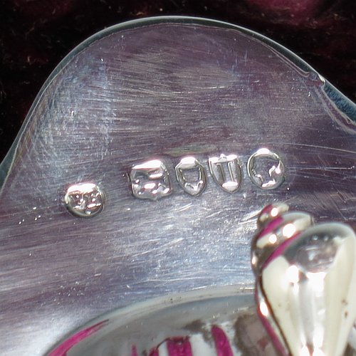 An Antique Victorian Sterling Silver set of four butter shells, having traditional scallop shapes, and sitting on three cast shell feet, together with four original butter knives in the Albany pattern, and all sitting in an original purple satin and velvet-lined presentation box. All made by Frances Higgins of London in 1884. The dimensions of this fine hand-made set of antique silver butter shells are length 12 cms (4.75 inches), width 10 cms (4 inches), with a total weight of approx. 385g (12.4 troy ounces).