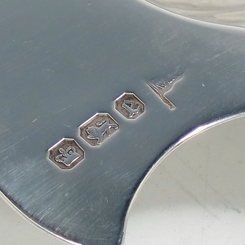 A very handsome Antique Victorian Sterling Silver pair of butter shells, having hand-chased scalloped bodies, plain shaped thumb-pieces, and both sitting on three cast shell-shaped feet. All made by Walker and Hall of Sheffield in 1897/99. The dimensions of these fine hand-made antique silver butter dishes are length 13 cms (5 inches), width 11 cms (4.25 inches), height 2.5 cms (1 inch), and they have a total weight of approx. 163g (5.25 troy ounces).
