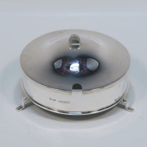 A handsome Sterling Silver and crystal butter dish and cover, having a very plain round body with straight sides, an original frosted crystal liner with star-cut base, a plain round and domes lift off lid, and all sitting on three flange feet. This elegant silver butter dish and cover was made by E. J. Houlston of Birmingham in 1946. The dimensions of this fine hand-made silver butter dish and cover are diameter 10 cms (4 inches), height 5 cms (2 inches), with a total weight of approx. 92g (3 troy ounces).   