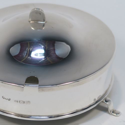 A handsome Sterling Silver and crystal butter dish and cover, having a very plain round body with straight sides, an original frosted crystal liner with star-cut base, a plain round and domes lift off lid, and all sitting on three flange feet. This elegant silver butter dish and cover was made by E. J. Houlston of Birmingham in 1946. The dimensions of this fine hand-made silver butter dish and cover are diameter 10 cms (4 inches), height 5 cms (2 inches), with a total weight of approx. 92g (3 troy ounces).