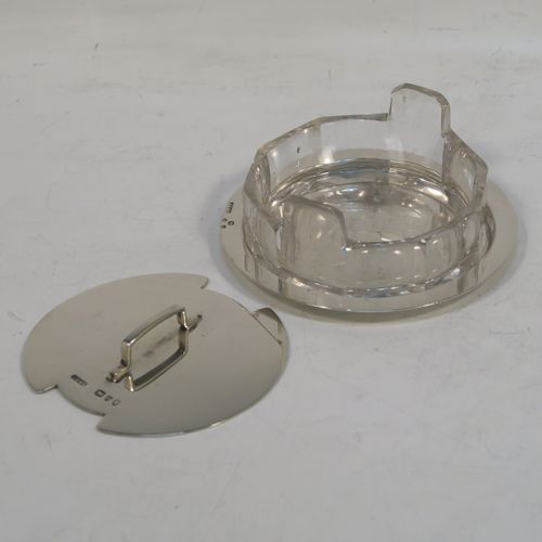 A very unusual Antique Victorian Sterling Silver and crystal butter dish and cover in an Arts and Crafts style, having a panelled crystal body with two side-handles, a lift-off plain round cover with handle, and all sitting in a plain round plate with a flat base. This elegant antique silver butter dish and cover was made by John Grinsell of London in 1893. The dimensions of this fine hand-made antique silver butter dish are diameter 8.5 cms (3.3 inches), height width 11 cms (4.25 inches), height 3.5 cms (1.3 inch), with a total weight of approx. 60g (2 troy ounces).