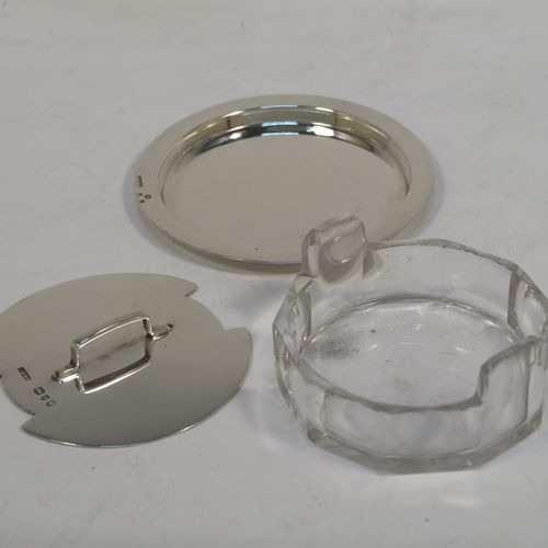 A very unusual Antique Victorian Sterling Silver and crystal butter dish and cover in an Arts and Crafts style, having a panelled crystal body with two side-handles, a lift-off plain round cover with handle, and all sitting in a plain round plate with a flat base. This elegant antique silver butter dish and cover was made by John Grinsell of London in 1893. The dimensions of this fine hand-made antique silver butter dish are diameter 8.5 cms (3.3 inches), height width 11 cms (4.25 inches), height 3.5 cms (1.3 inch), with a total weight of approx. 60g (2 troy ounces).
