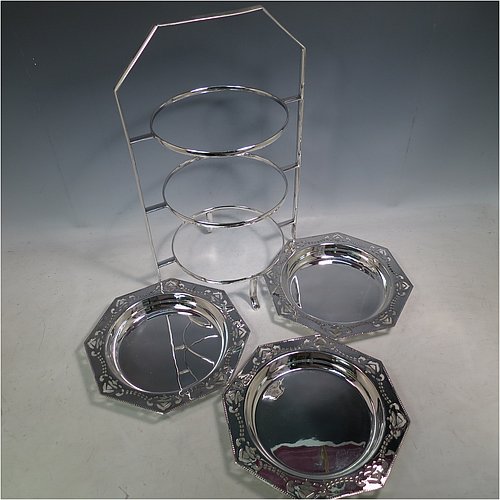 An Antique Edwardian very pretty silver-plated cake stand, having three removable octagonal dishes with hand-pierced borders showing pairs of Swallows, all held in a plain wire-work frame with a carrying handle and four scroll feet. All made in ca. 1900. The dimensions of this fine hand-made antique silver-plated cake stand are height 43 cms (17inches), width 30.5 cms (12 inchs), and the diameter of the inside of the dishes is 18 cms (7 inches).   