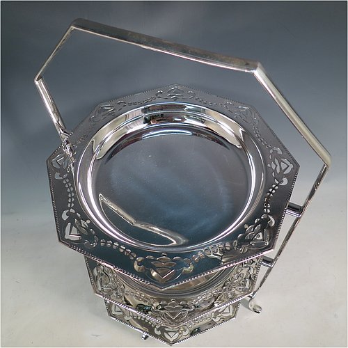 An Antique Edwardian very pretty silver-plated cake stand, having three removable octagonal dishes with hand-pierced borders showing pairs of Swallows, all held in a plain wire-work frame with a carrying handle and four scroll feet. All made in ca. 1900. The dimensions of this fine hand-made antique silver-plated cake stand are height 43 cms (17inches), width 30.5 cms (12 inchs), and the diameter of the inside of the dishes is 18 cms (7 inches).   