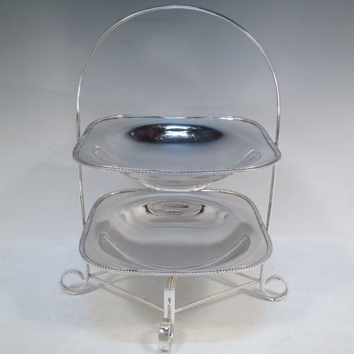 A pretty Antique Edwardian silver-plated cake stand, having two removable recessed plates with square bodies, rounded shoulders, and applied egg and dart borders. All sitting in a plain wire-work frame which in-turn sits on four scroll feet. All made in ca. 1910 by Daniel and Arter of Sheffield. The dimensions of this fine hand-made antique silver-plated cake stand are height 32 cms (12.5 inches), width 26 cms (10.25 inches), and the plates are 19 cms (7.5 inches) square.   