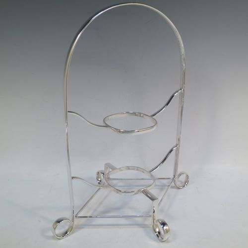 A pretty Antique Edwardian silver-plated cake stand, having two removable recessed plates with square bodies, rounded shoulders, and applied egg and dart borders. All sitting in a plain wire-work frame which in-turn sits on four scroll feet. All made in ca. 1910 by Daniel and Arter of Sheffield. The dimensions of this fine hand-made antique silver-plated cake stand are height 32 cms (12.5 inches), width 26 cms (10.25 inches), and the plates are 19 cms (7.5 inches) square.