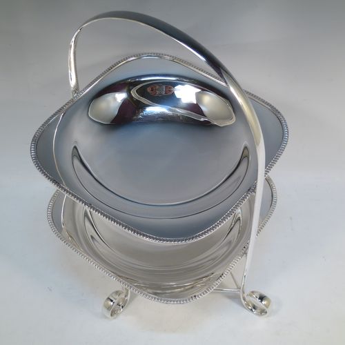A pretty Antique Edwardian silver-plated cake stand, having two removable recessed plates with square bodies, rounded shoulders, and applied egg and dart borders. All sitting in a plain wire-work frame which in-turn sits on four scroll feet. All made in ca. 1910 by Daniel and Arter of Sheffield. The dimensions of this fine hand-made antique silver-plated cake stand are height 32 cms (12.5 inches), width 26 cms (10.25 inches), and the plates are 19 cms (7.5 inches) square.