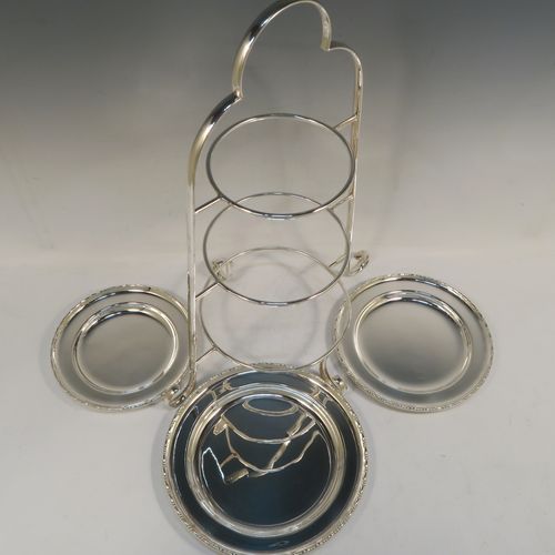 A very pretty Antique Edwardian silver plated three-tier cake stand, having a graduated suite of three removable round plates with applied egg and dart, sitting within a very handsome tapering frame with scroll-work handle and feet. This beautiful antique silver-plated three-tier cake stand was made in ca. 1910. The dimensions of this fine hand-made silver-plated cake stand are height 42 cms (16.5 inches), width at base 30.5 cms (12 inches), diameter of largest plate 20 cms (8 inches), and of of smallest plate 16 cms (6.3 inches).