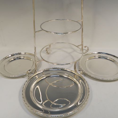 A very pretty Antique Edwardian silver plated three-tier cake stand, having a graduated suite of three removable round plates with applied egg and dart, sitting within a very handsome tapering frame with scroll-work handle and feet. This beautiful antique silver-plated three-tier cake stand was made in ca. 1910. The dimensions of this fine hand-made silver-plated cake stand are height 42 cms (16.5 inches), width at base 30.5 cms (12 inches), diameter of largest plate 20 cms (8 inches), and of of smallest plate 16 cms (6.3 inches).