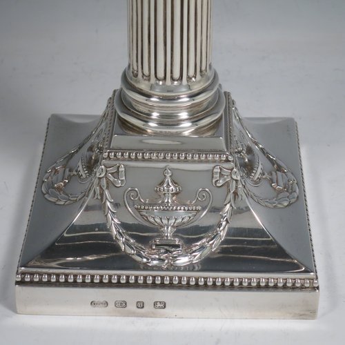 An Antique Victorian Sterling Silver single five-light candelabrum in a Corinthian style having Neoclassical hand-chased decoration, sitting on a square base, a fluted column with acanthus leaf style arms and capitals, removable nozzles with drip pans, and gadroon edge borders. Made by Elkington & Co., of Birmingham in 1895. The dimensions of this fine hand-made antique silver candelabrum are height 52 cms (20.5 inches), and spread across arms 38 cms (15 inches). Please note that this item can be converted into a three-light candelabrum.