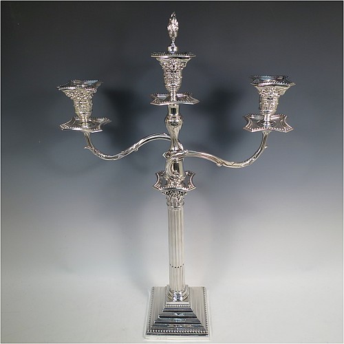 A very pretty Antique Victorian Sterling Silver single candelabrum, having three lights in a Corinthian style with a stepped square base, a fluted round column, double swirl acanthus leaf arms and capitals, removable nozzles with drip pans and central extinguisher with cast flame finial, and bead-edged borders. Made by Fordham and Faulkner of London in 1897. The dimensions of this fine hand-made antique silver single candelabrum are height 63.5 cms (25 inches), and spread across arms 38 cms (15 inches).    
