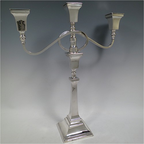 A very handsome Sterling Silver single Art Deco style candelabrum, having a square stepped base with an applied lower bead border, a plain panelled column with tapering sides, with double swirl reeded arms and matching capitals with removable nozzles. Made by Britton Gould and Co., of Birmingham in 1935. The dimensions of this fine hand-made silver Art Deco single candelabrum are height 41 cms (16.25 inches), spread across arms 33.5 cms (13.25 inches), and it weighs approx. 957g (31 troy ounces). Please note that this candelabrum is not filled, so the whole weight is silver.   