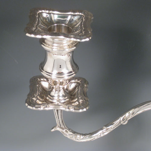 Antique Edwardian sterling silver pair of three-light candelabra with removable arms, plain baluster bodies with cut-corner borders, and original removable nozzles. Made by Fordham and Faulkner of Sheffield 1905. Height 50 cms (19.75 inches), spread across branches 38.5 cms (14.3 inches). 