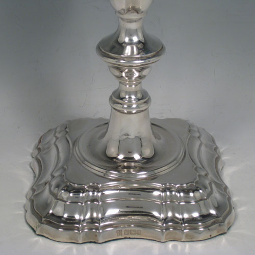 Antique Edwardian sterling silver pair of three-light candelabra with removable arms, plain baluster bodies with cut-corner borders, and original removable nozzles. Made by Fordham and Faulkner of Sheffield 1905. Height 50 cms (19.75 inches), spread across branches 38.5 cms (14.3 inches). 
