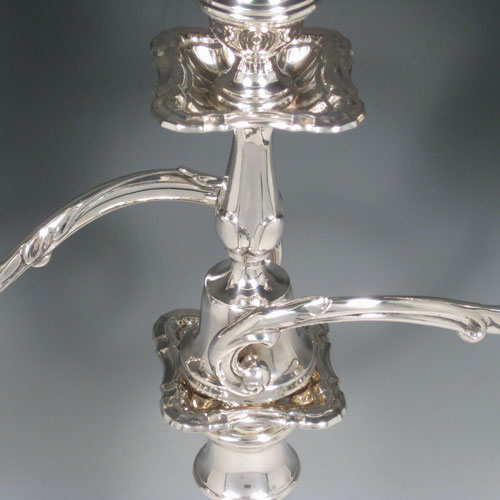 Antique Edwardian sterling silver pair of three-light candelabra with removable arms, plain baluster bodies with cut-corner borders, and original removable nozzles. Made by Fordham and Faulkner of Sheffield 1905. Height 50 cms (19.75 inches), spread across branches 38.5 cms (14.3 inches). 