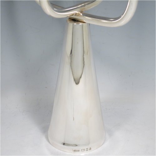 A Sterling Silver single candelabrum, in a  very plain Modernistic style, having four branched lights with tapering nozzles, all sitting on a cone-shaped base. The base, arms, and nozzles all screw together for ease of cleaning and storage. Made by A. Taite & Sons of London in 1970. The dimensions of this fine hand-made silver single candelabrum are height 43 cms (17 inches), and spread across arms 17 cms (6.75 inches).    
