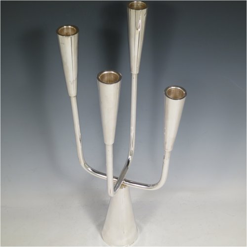 A Sterling Silver single candelabrum, in a  very plain Modernistic style, having four branched lights with tapering nozzles, all sitting on a cone-shaped base. The base, arms, and nozzles all screw together for ease of cleaning and storage. Made by A. Taite & Sons of London in 1970. The dimensions of this fine hand-made silver single candelabrum are height 43 cms (17 inches), and spread across arms 17 cms (6.75 inches).    