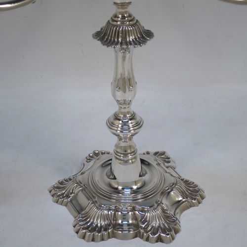 A handsome Sterling Silver cast single candelabrum in a George II style six-shell style, having removable three-light scroll arms with nozzles, and a central finial. Made in Birmingham in 1971. The dimensions of this fine hand-made silver three-light candelabrum are height 29 cms (11.5 inches), spread across arms 27 cms (10.75 inches), and with a total weight of approx. 1,300g (42 troy ounces). Please note that this candelabrum is all cast and not filled, so the whole weight is silver.   