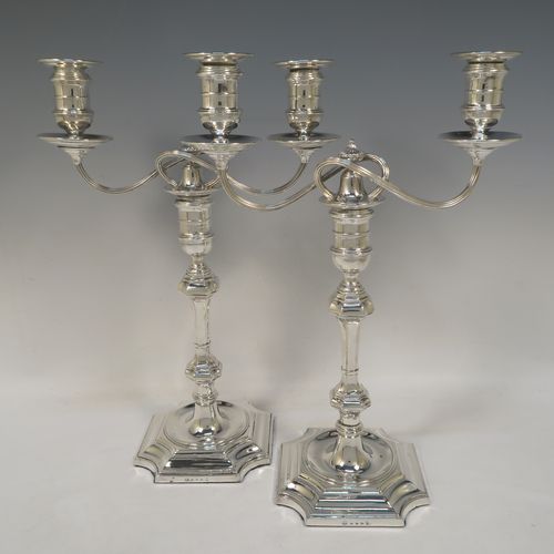 A very handsome pair of Antique Victorian two-light Silver Plated Georgian style candelabra, having cut-corner square bases, panelled baluster columns, with removable swirl and reeded arms, and matching capitals with drip pans and removable nozzles. Made by Elkington and Co., with a date letter for 1896. The dimensions of this fine hand-made pair silver-plated Georgian style  candelabra are height 35 cms (13.75 inches), and spread across arms 25 cms (10 inches).  