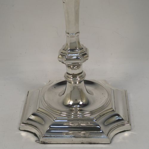 A very handsome pair of Antique Victorian two-light Silver Plated Georgian style candelabra, having cut-corner square bases, panelled baluster columns, with removable swirl and reeded arms, and matching capitals with drip pans and removable nozzles. Made by Elkington and Co., with a date letter for 1896. The dimensions of this fine hand-made pair silver-plated Georgian style  candelabra are height 35 cms (13.75 inches), and spread across arms 25 cms (10 inches).  