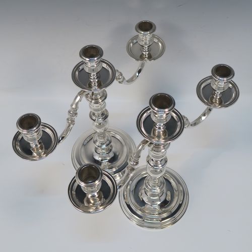 An elegant Sterling Silver cast pair of George I style three-light candelabra, having plain round and baluster style bodies, with removable scroll arms with nozzles and drip pans. This handsome pair of candelabra were made by Wakely and Wheeler of London in 1977. The dimensions of this fine hand-made pair of silver candelabra are height 26 cms (10.25 inches), spread across arms 29 cms (11.5 inches), and with a total weight of approx. 1,900g (61.3 troy ounces). Please note that these candelabra are not filled, so the whole weight is silver.