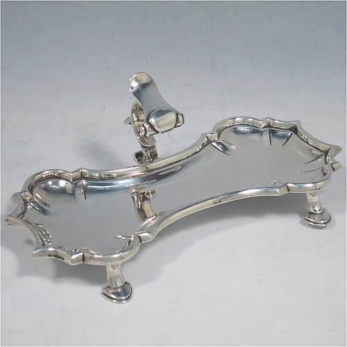 An Antique Georgian Sterling Silver candle scissor snuffer stand, having a plain shaped rectangular body, with an applied Chippendale border, a cast scroll handle with thumb-piece, and sitting on four cast hoof feet. Made by John Hyatt of London in 1761. The dimensions of this fine hand-made antique silver snuffer stand are length 18 cms (7 inches), height including handle 7 cms (2.75 inches), width 9 cms (3.5 inches), and it weighs approx. 217g (7 troy ounces).   