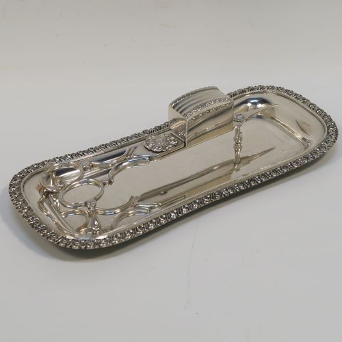 A very handsome Antique Georgian Old Sheffield Plated candle scissor snuffer stand and candle scissor snuffer, the stand having an applied floral & gadroon border, a plain undecorated ground, and sitting on a flat base with four stud feet and original tin backing . The scissor snuffer with matching decoration and all in original working condition. This beautiful antique Old Sheffield plated candle scissor snuffer and stand was made in ca. 1810. The dimensions of this fine hand-made antique Old Sheffield Plated snuffer stand and scissors are length 23 cms (9 inches), and width 10 cms (4 inches),  