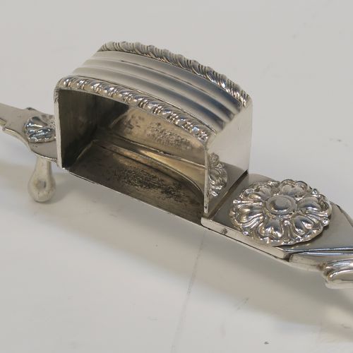 A very handsome Antique Georgian Old Sheffield Plated candle scissor snuffer stand and candle scissor snuffer, the stand having an applied floral & gadroon border, a plain undecorated ground, and sitting on a flat base with four stud feet and original tin backing . The scissor snuffer with matching decoration and all in original working condition. This beautiful antique Old Sheffield plated candle scissor snuffer and stand was made in ca. 1810. The dimensions of this fine hand-made antique Old Sheffield Plated snuffer stand and scissors are length 23 cms (9 inches), and width 10 cms (4 inches),