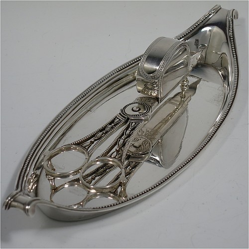 An Antique Georgian Sterling Silver candle scissor snuffer and stand, in a neoclassical style with applied bead-edged borders, and an oval boat-shaped stand. The scissor snuffers made by Walter Brind of London in 1789, and the stand made by John Schofield of London in 1785 (this hallmark has a rare Incuse Duty mark). The dimensions of this fine hand-made antique silver scissor snuffer and stand are length 24 cms (9.5 inches), width 9.5 cms (3.75 inches), and they weigh a total of approx. 213g (6.9 troy ounces).    