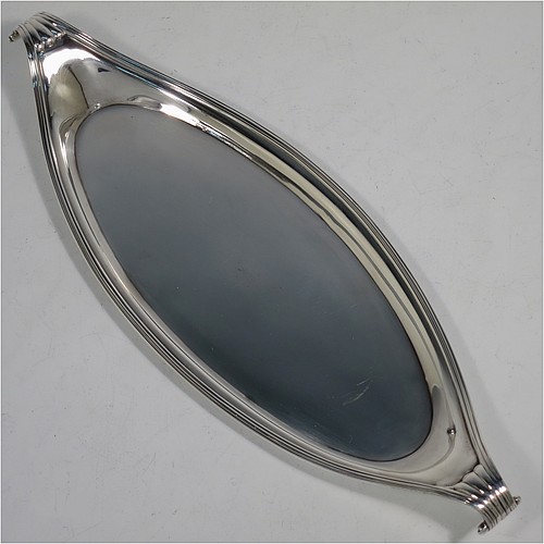 A very handsome Antique Georgian Sterling Silver candle scissor snuffer and stand, in a neoclassical style with applied reed-edged borders, and an oval boat-shaped stand. Made by Walter Brind of London in 1800. The dimensions of this fine hand-made antique silver scissor snuffer and stand are length 26 cms (10.25 inches), width 9 cms (3.5 inches), and they weigh a total of approx. 208g (6.7 troy ounces).