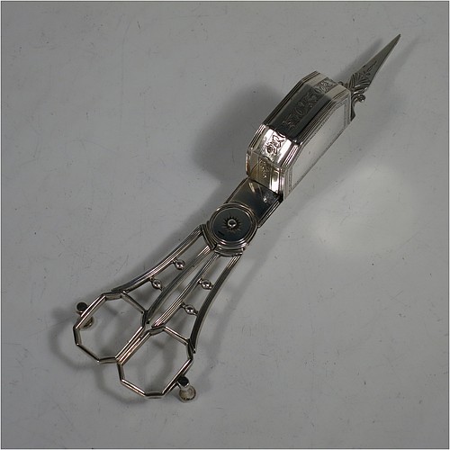 A very handsome Antique Georgian Sterling Silver candle scissor snuffer and stand, in a neoclassical style with applied reed-edged borders, and an oval boat-shaped stand. Made by Walter Brind of London in 1800. The dimensions of this fine hand-made antique silver scissor snuffer and stand are length 26 cms (10.25 inches), width 9 cms (3.5 inches), and they weigh a total of approx. 208g (6.7 troy ounces).