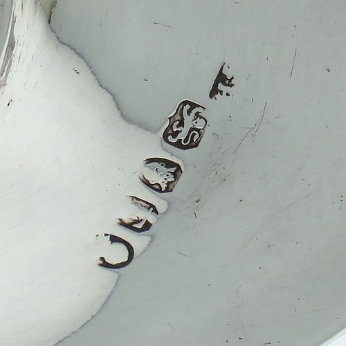 A handsome Antique Georgian Sterling Silver candle scissor snuffer stand or tray, having a plain elongated oval-shaped body with a central vacant cartouche surrounded by hand-engraved scroll-work and laurel leaves, an applied reeded border, and sitting on a flat base. Made by Soloman Hougham of London in 1800. The dimensions of this fine hand-made antique silver snuffer tray or stand are length 24 cms (9.5 inches), width 10.5 cms (4.25 inches), and it weighs approx. 127g (4 troy ounces).
