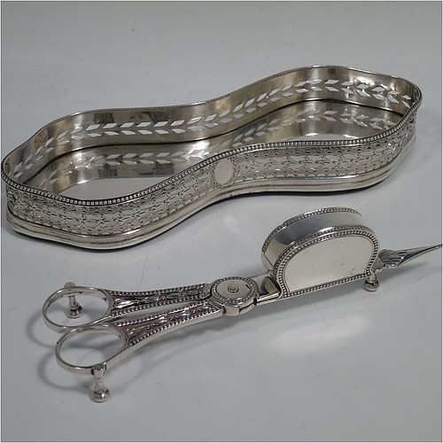 A very pretty Antique Georgian Sterling Silver candle scissor snuffer and stand, in a neoclassical style with applied bead-edged borders, sitting in a hand-pierced and galleried stand with hand-engraved floral decoration. Made in London in 1779, the scissor snuffer by John Buckett, and the stand by James Stamp. The dimensions of this fine hand-made antique silver scissor snuffer and stand are length of stand 20 cms (8 inches), width at widest point 7 cms (2.75 inches), and they weigh a total of approx. 248g (8 troy ounces).    