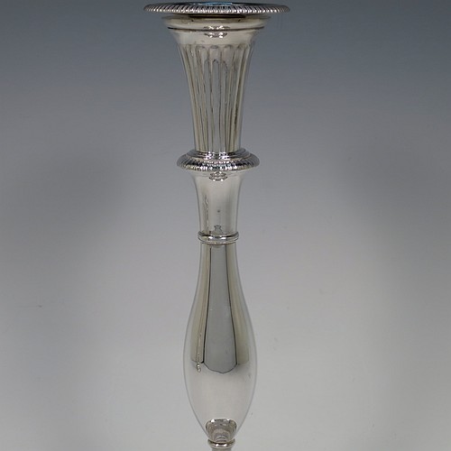 An Antique Georgian Sterling Silver pair of candlesticks, having round bellied bodies with hand-chased fluted decoration, with gadroon borders, and removable nozzles. Made by John Green, Roberts, Mosley and Co., of Sheffield in 1800. The dimensions of these fine hand-made antique silver candlesticks are height 30 cms (11.75 inches), diameter of bases 13.5 cms (5.3 inches) diameter. Please note that these candlesticks are filled.    