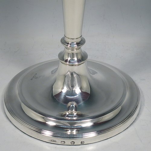 An Antique Georgian Sterling Silver set of four large table candlesticks, in a plain round style, having round bodies with reeded borders, tapering columns, and removable nozzles. Made by John Waterhouse & Co., of Sheffield in 1782. The dimensions of these fine hand-made antique silver candlesticks are height 27.5 cms (10.75 inches), and diameter at bases 14 cms (5.5 inches). Please note that these candlesticks are crested.   