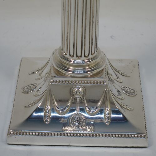 A very handsome set of four Antique Victorian Silver Plated table candlesticks, in a Neoclassical Corinthian style having square stepped bases with swag and lion-mask decoration, fluted columns, laurel leaf swag capitals, removable nozzles, and bead-edged borders. Made by Hawksworth Eyre and Co., of Sheffield in ca. 1880. The dimensions of this fine hand-made set of four antique silver-plated candlesticks are height 26 cms (10.25 inches), and their bases are 11 cms (4.3 inches) square.