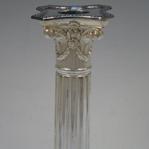 A very handsome set of four Antique Victorian Silver Plated table candlesticks, in a Neoclassical Corinthian style having square stepped bases with swag and lion-mask decoration, fluted columns, laurel leaf swag capitals, removable nozzles, and bead-edged borders. Made by Hawksworth Eyre and Co., of Sheffield in ca. 1880. The dimensions of this fine hand-made set of four antique silver-plated candlesticks are height 26 cms (10.25 inches), and their bases are 11 cms (4.3 inches) square.