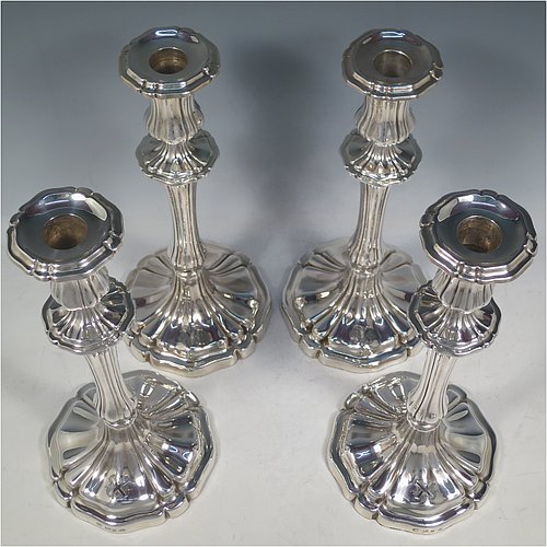 An Antique Georgian Sterling Silver set of four large table candlesticks, having round bodies with hand-chased Melon style fluting, with tapering columns and removable nozzles. Made by Henry Wilkinson of Sheffield in 1835. The dimensions of these fine hand-made antique silver candlesticks are height 28 cms (11 inches), diameter at base 13.5 cms (5.25 inches). Please note that these candlesticks are crested.