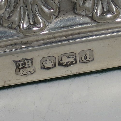 A very pretty set of four Sterling Silver candlesticks in a Neoclassical style, having round baluster bodies with hand-chased anthemion leaf and fluted decoration, with anthemion leaf-edged borders, sitting on square bases with matching decoration, and original removable nozzles. This beautiful set of silver candlesticks were made by Thomas Bradbury of Sheffield in 1921. The dimensions of these fine hand-made silver candlesticks are height 28 cms (11 inches), base 12 cms (4.75 inches) square.