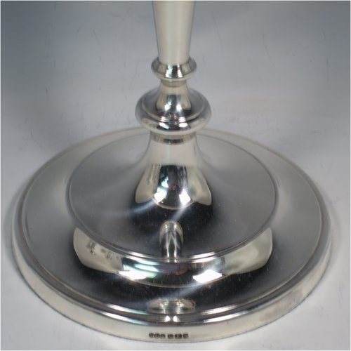 An Antique Victorian Sterling Silver set of four large table candlesticks, in a plain round style, having round bodies with hand-chased reeded borders, tapering columns, and removable nozzles. Made by Elkington & Co., of Sheffield in 1899. The dimensions of these fine hand-made antique silver candlesticks are height 29 cms (11.5 inches), and diameter at bases 14 cms (5.5 inches).   