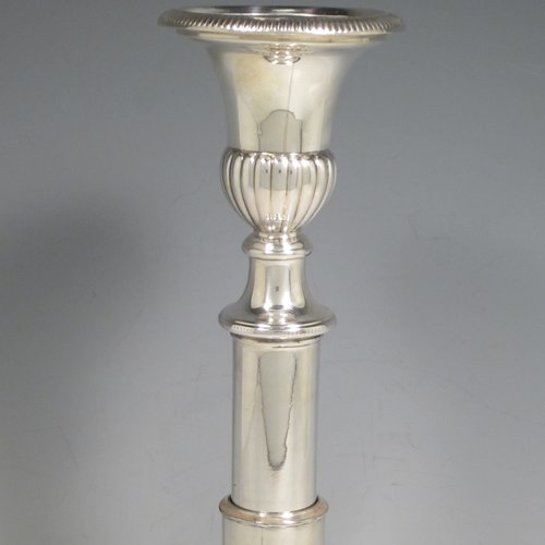 Antique Georgian sterling silver pair of rare telescopic candlesticks, having round baluster bases and plain straight-sided collumns, with gadroon borders, and removable nozzles. Made by George Ashford & Co., of Sheffield in 1804. The dimensions of these fine hand-made silver candlesticks are height 25 cms (9.75 inches), and when extended 30 cms (11.75 inches), and base 13.5 cms (5.25 inches) diameter. 