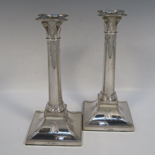 A very pretty pair of Antique Victorian Sterling Silver table candlesticks, in a Neoclassical Corinthian style having square bases with swags, ribbon and bows, and bead-work decoration, and removable nozzles. These beautiful silver candlesticks were made by Thomas Bradbury of London in 1897. The dimensions of this fine hand-made pair  of antique silver candlesticks are height 23.5 cms (9.25 inches), and their bases are 11 cms (4.25 inches) square.   