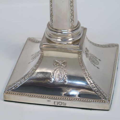 A very pretty pair of Antique Victorian Sterling Silver table candlesticks, in a Neoclassical Corinthian style having square bases with swags, ribbon and bows, and bead-work decoration, and removable nozzles. These beautiful silver candlesticks were made by Thomas Bradbury of London in 1897. The dimensions of this fine hand-made pair of antique silver candlesticks are height 23.5 cms (9.25 inches), and their bases are 11 cms (4.25 inches) square.