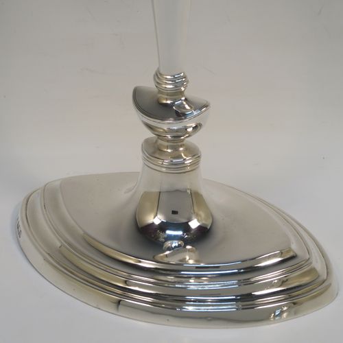 A very handsome pair of Antique Edwardian Sterling Silver candlesticks, having neoclassical plain oval boat-shaped bodies with reeded borders and tapering columns, and original removable nozzles. These elegant antique silver candlesticks were made by Thomas Bradbury of Sheffield in 1903. The dimensions of these fine hand-made antique silver candlesticks are height 30.5 cms (12 inches), and the bases are 17 cms (6.75 inches) long.