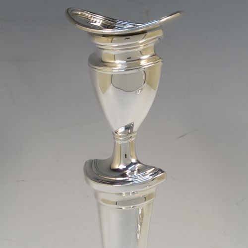 A very handsome pair of Antique Edwardian Sterling Silver candlesticks, having neoclassical plain oval boat-shaped bodies with reeded borders and tapering columns, and original removable nozzles. These elegant antique silver candlesticks were made by Thomas Bradbury of Sheffield in 1903. The dimensions of these fine hand-made antique silver candlesticks are height 30.5 cms (12 inches), and the bases are 17 cms (6.75 inches) long.