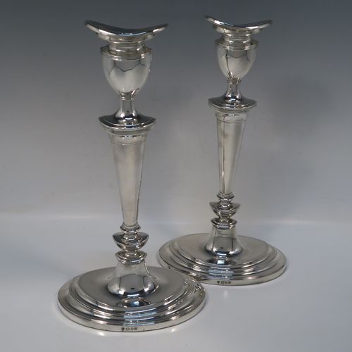 A very handsome and large pair of Sterling Silver candlesticks, having neoclassical plain oval boat-shaped bodies with reeded borders and tapering columns, and original removable nozzles. These elegant silver candlesticks were made by D. J. Silver of London in 1965. The dimensions of these fine hand-made silver candlesticks are height 30.5 cms (12 inches), and the bases are 16.5 cms (6.5 inches) long.   