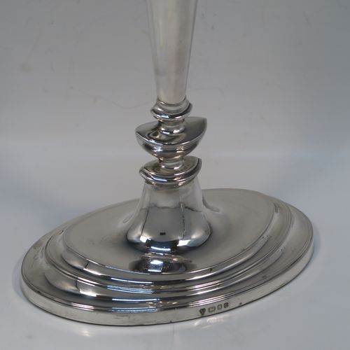 A very handsome and large pair of Sterling Silver candlesticks, having neoclassical plain oval boat-shaped bodies with reeded borders and tapering columns, and original removable nozzles. These elegant silver candlesticks were made by D. J. Silver of London in 1965. The dimensions of these fine hand-made silver candlesticks are height 30.5 cms (12 inches), and the bases are 16.5 cms (6.5 inches) long.   